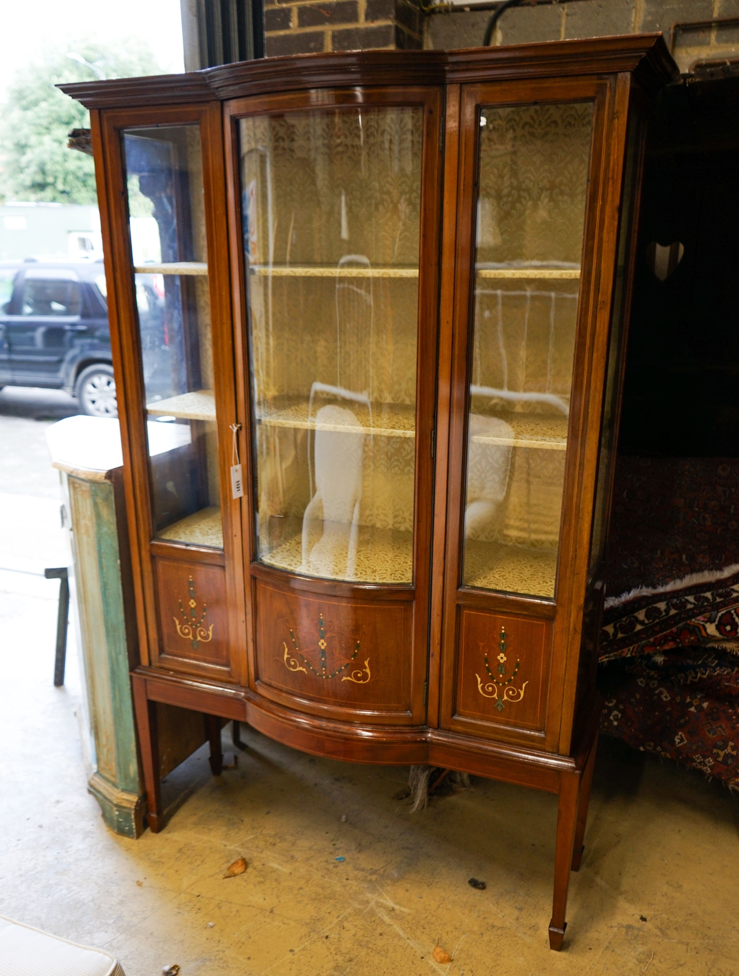 An Edwardian inlaid mahogany bow front display cabinet, width 115cm, depth 43cm, height 178cm
